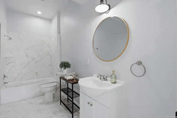 a bathroom with a sink toilet and shower