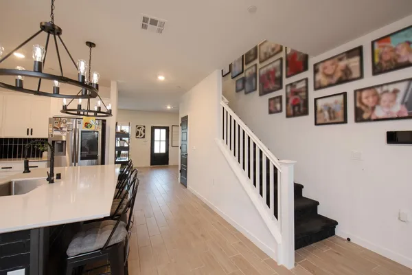 a dining room with furniture and a chandelier