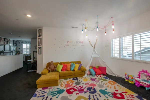 a living room with furniture and a chandelier