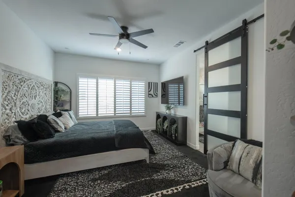 a bed room with a bed window and a couch