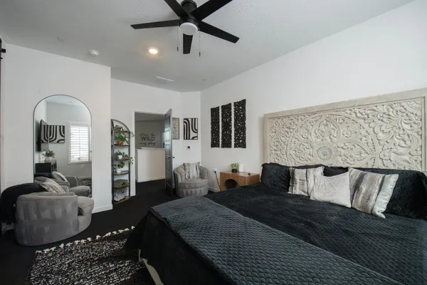 a bedroom with bed and balcony