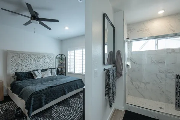 a bedroom with a bed and a mirror