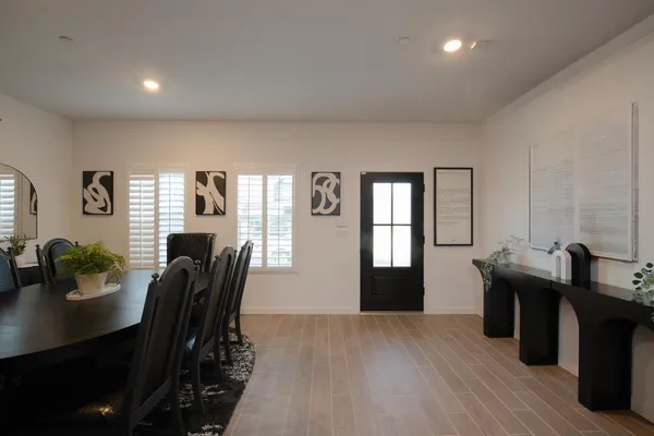 a view of a dining room with furniture and window