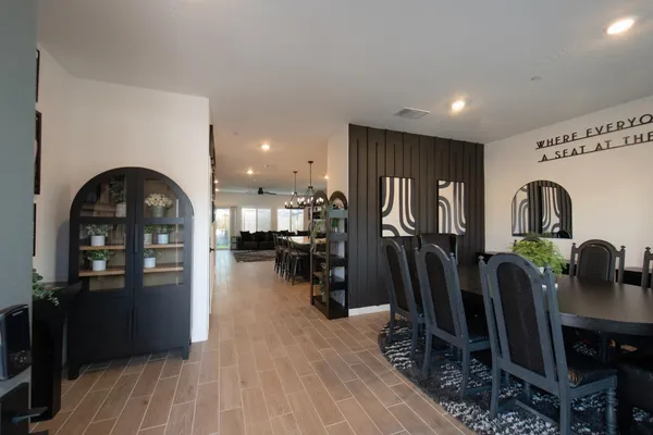 a kitchen with stainless steel appliances granite countertop a refrigerator a stove and a wooden floors
