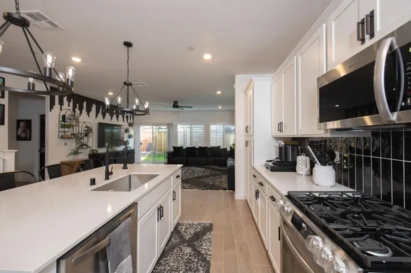 a kitchen with a sink stove and microwave