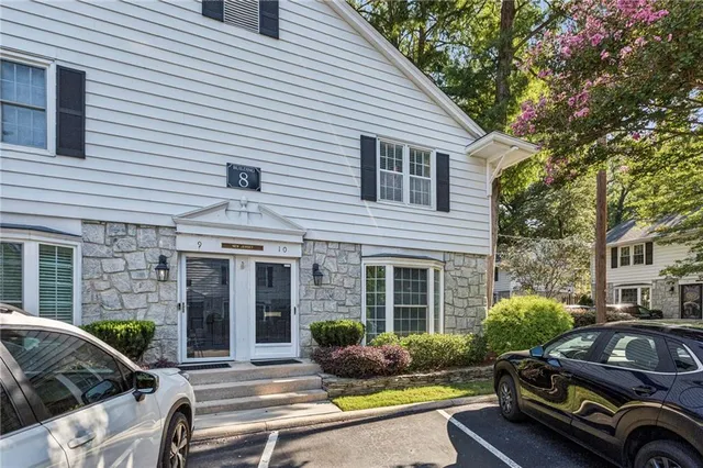 a car parked in front of a white house