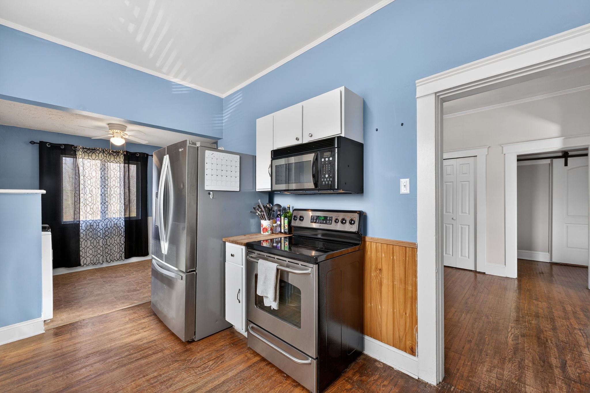 1360 Dunavin Drive Baxter, TN 38544 - Photo 12 of 24 a kitchen with stainless steel appliances a stove a microwave a sink a refrigerator and wooden floor