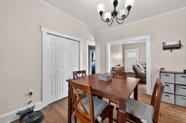 a view of a dining room with furniture and wooden floor