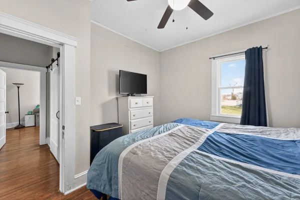 a bedroom with a bed and a flat screen tv