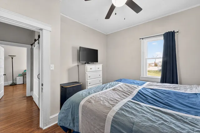 a bedroom with a bed and a flat screen tv
