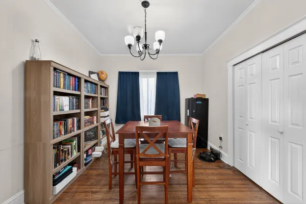 a view of a dining room with furniture and wooden floor