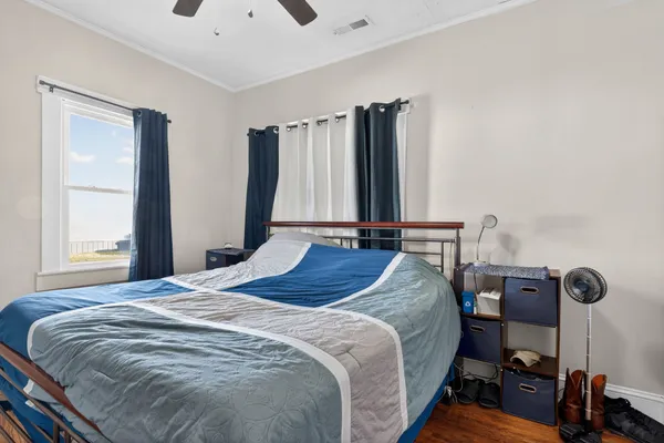 a bed sitting in a bedroom next to a window