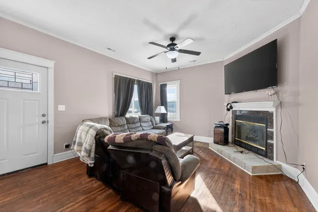 a bed room with a bed a flat screen tv and a fireplace