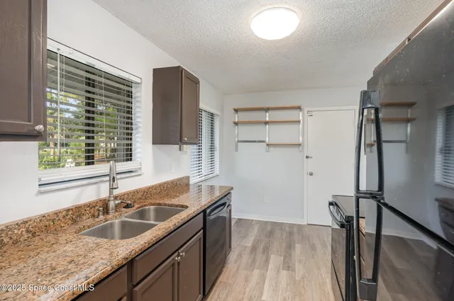 a kitchen with granite countertop a sink and a window