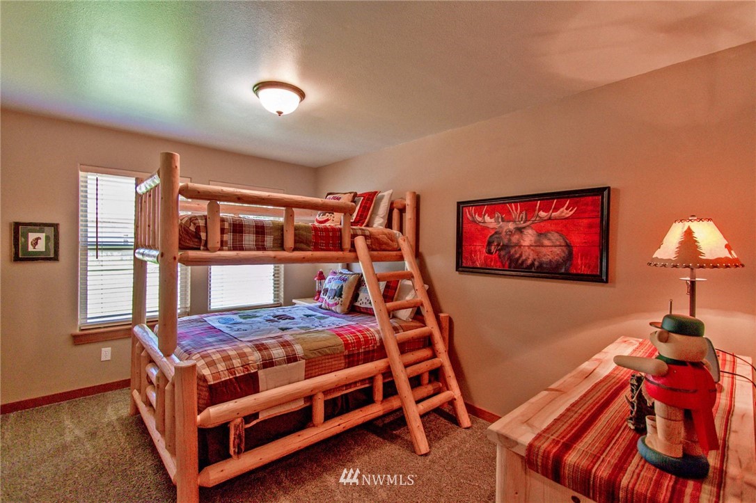 21 Paintbrush Lane Ronald, WA 98940 - Photo 14 of 27 a bedroom with a bed and a chandelier