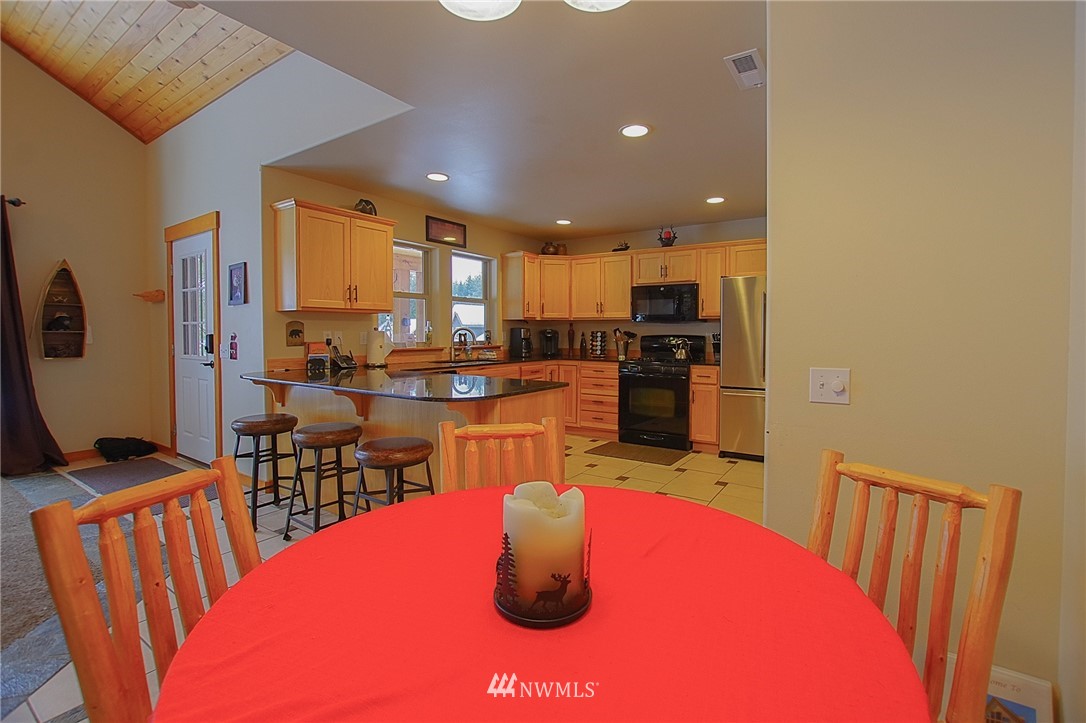 21 Paintbrush Lane Ronald, WA 98940 - Photo 9 of 27 a kitchen with stainless steel appliances kitchen island granite countertop a table chairs and a refrigerator