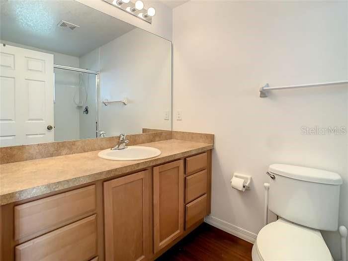 2685 Shelby Ruth Place St. Cloud, FL 34769 - Photo 12 of 16 a bathroom with a granite countertop sink toilet and mirror