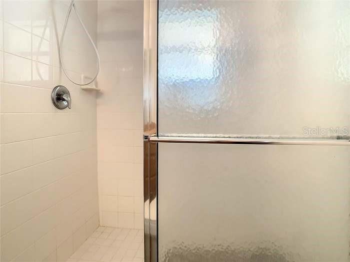 2685 Shelby Ruth Place St. Cloud, FL 34769 - Photo 13 of 16 a bathroom with a glass shower door