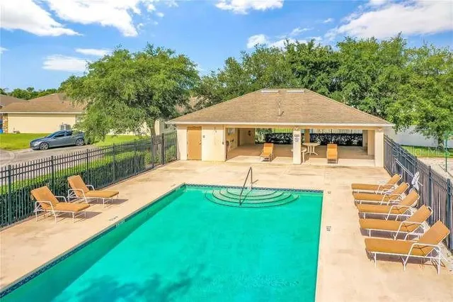 a view of an house with backyard space and balcony