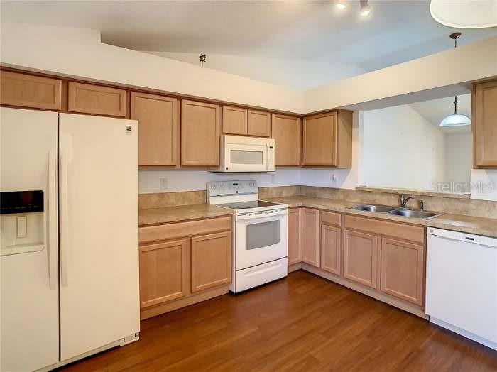 2685 Shelby Ruth Place St. Cloud, FL 34769 - Photo 2 of 16 a kitchen with stainless steel appliances white cabinets and a refrigerator
