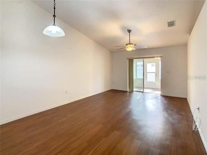 2685 Shelby Ruth Place St. Cloud, FL 34769 - Photo 6 of 16 a view of an empty room with a window and wooden floor
