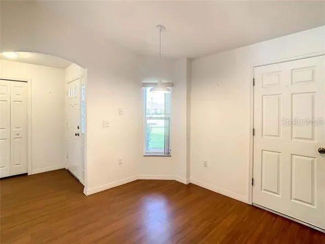 a view of a kitchen with a refrigerator and a sink