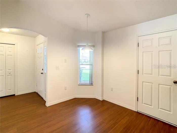 2685 Shelby Ruth Place St. Cloud, FL 34769 - Photo 8 of 16 an empty room with wooden floor and windows