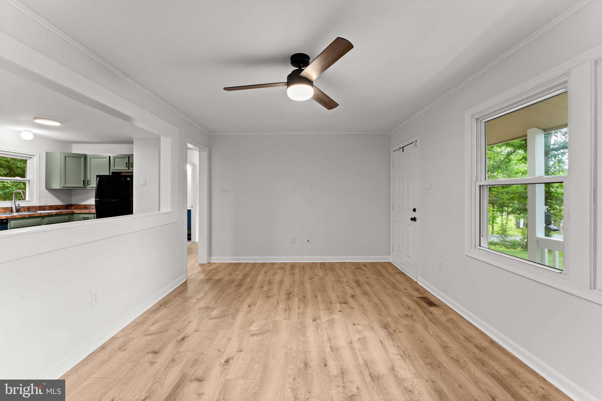 1821 James City Road Reva, VA 22735 - Photo 8 of 44 a view of empty room with wooden floor and fan
