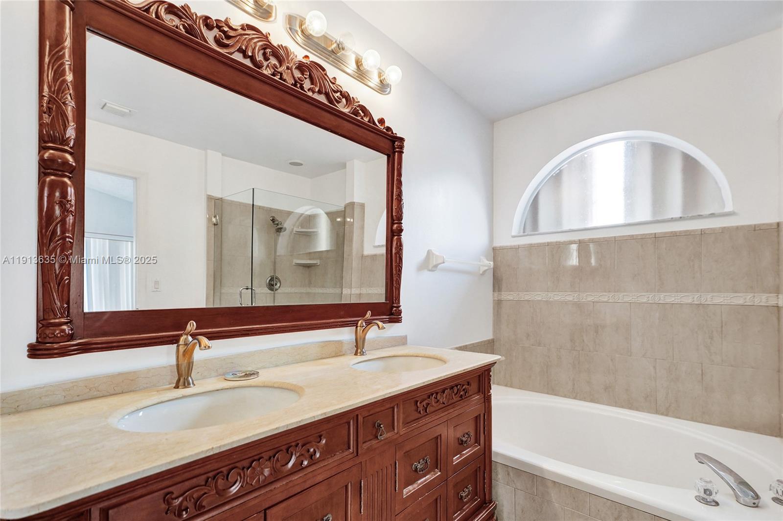 8007 Southwest 157th Place Miami, FL 33193 - Photo 19 of 51 a bathroom with a sink and a bathtub