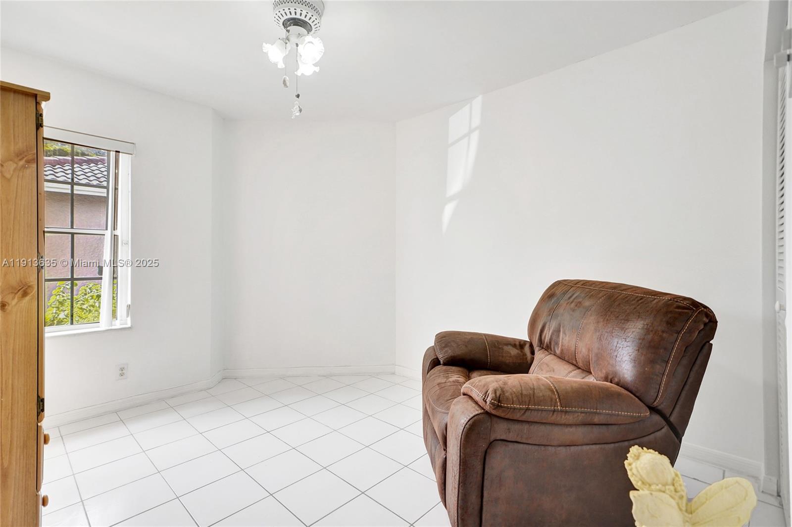 8007 Southwest 157th Place Miami, FL 33193 - Photo 35 of 51 a living room with furniture and a window