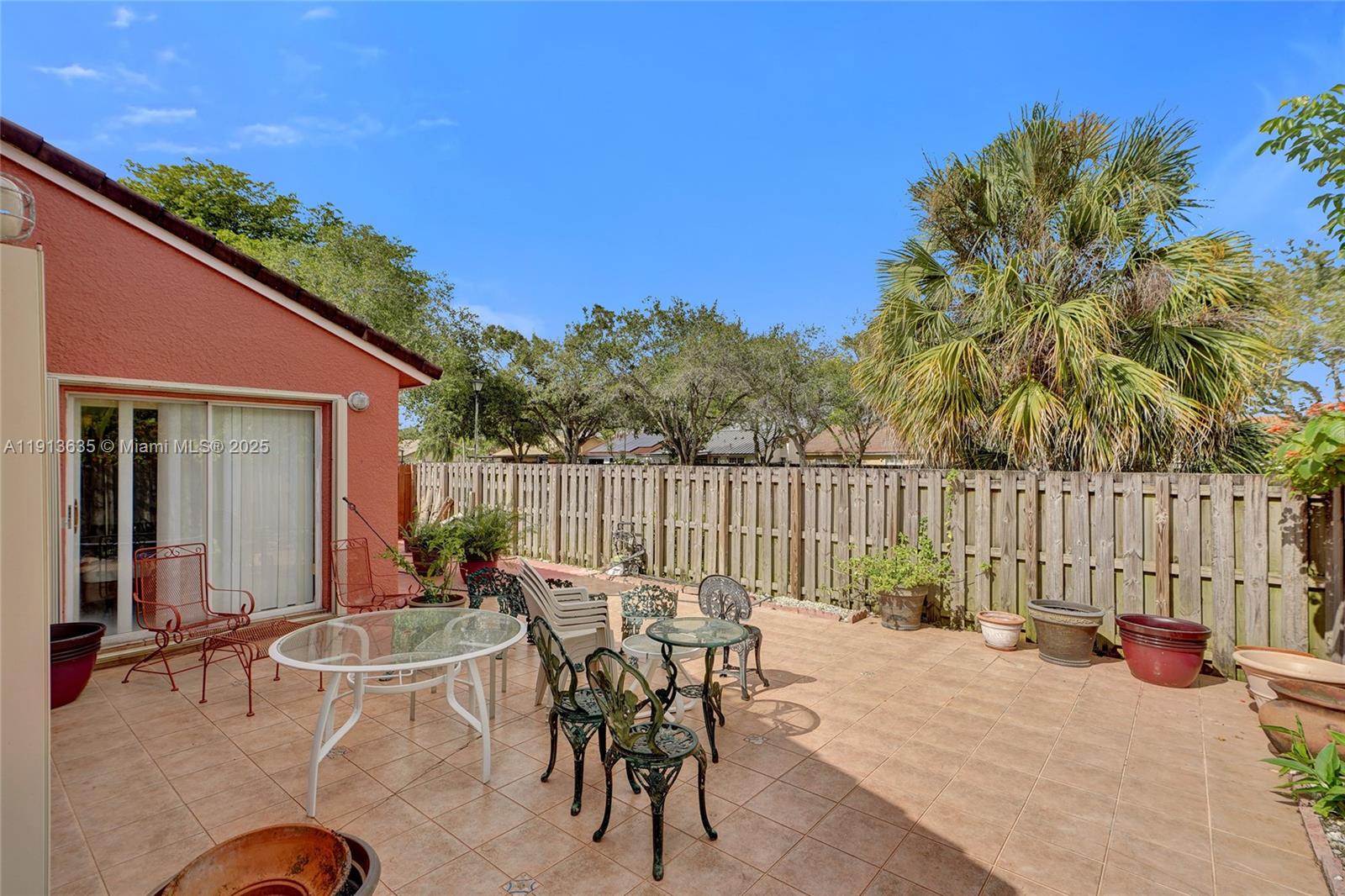 8007 Southwest 157th Place Miami, FL 33193 - Photo 36 of 51 a view of a patio with a table and chairs