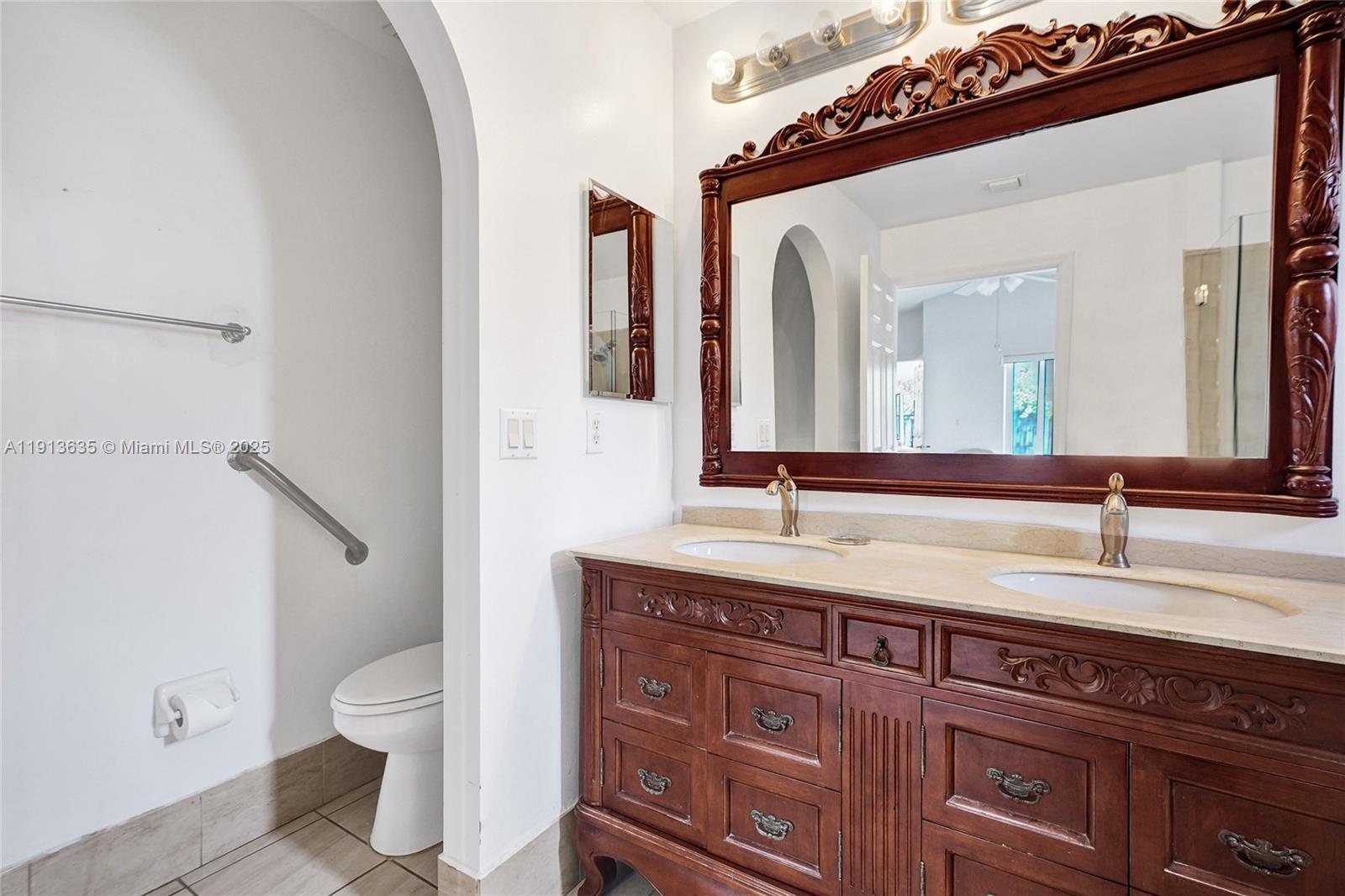 8007 Southwest 157th Place Miami, FL 33193 - Photo 37 of 51 a spacious bathroom with a granite countertop sink and a mirror