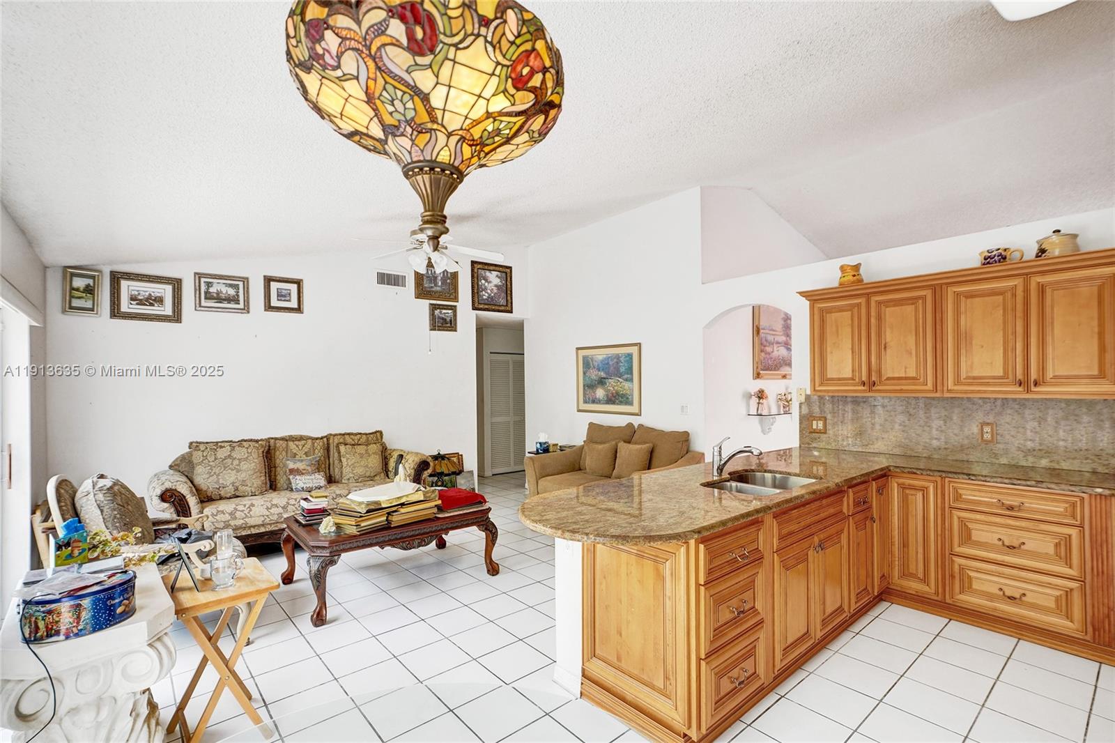 8007 Southwest 157th Place Miami, FL 33193 - Photo 4 of 51 a living room with furniture and a chandelier