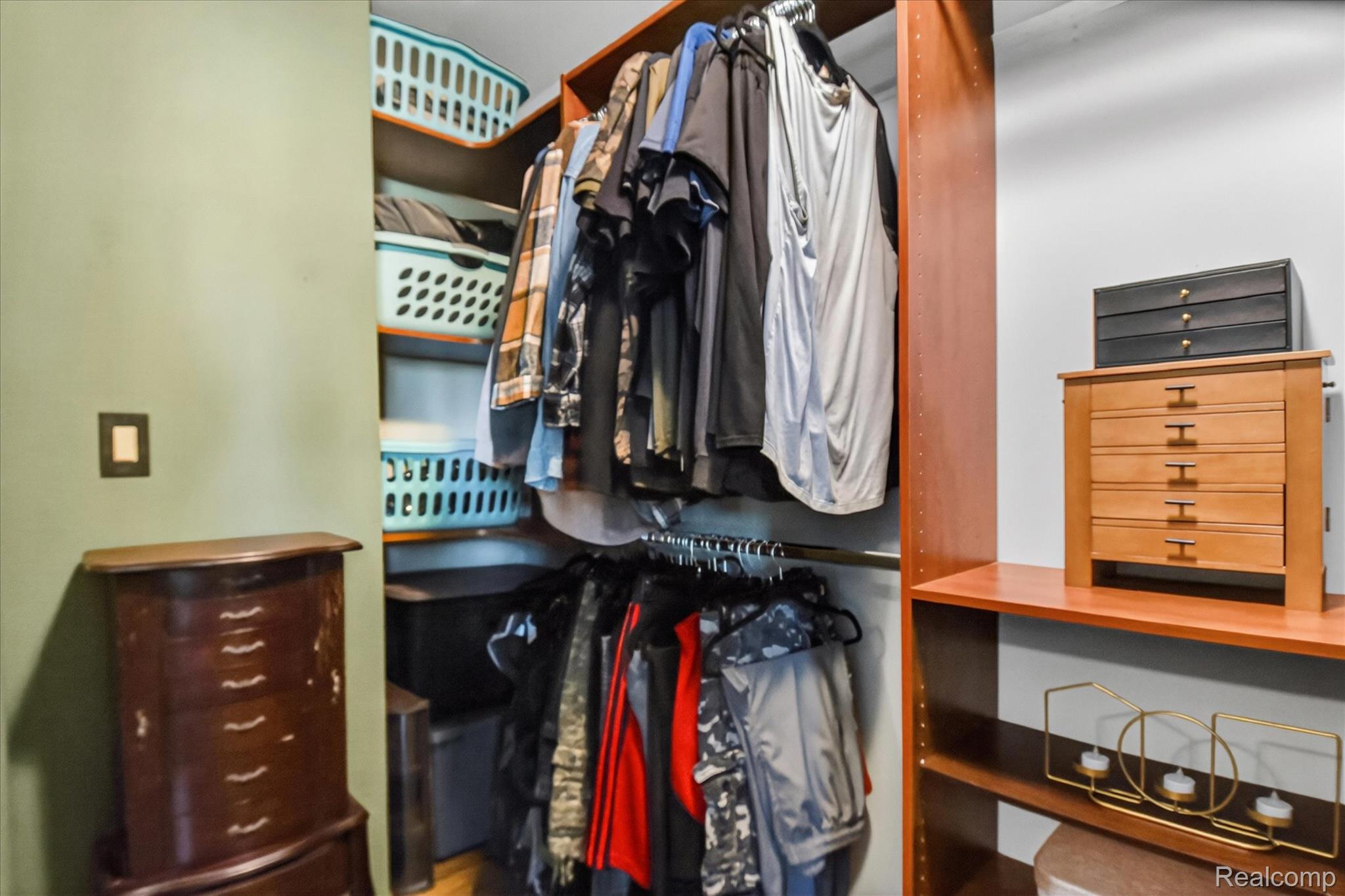 3949 West Burns Line Road Brown City, MI 48416 - Photo 28 of 70 Built-in closet system featuring wood-finish shelving, hanging rods, and ample storage space