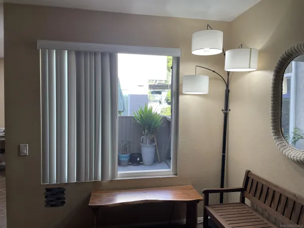a view of a room with a door and wooden floor