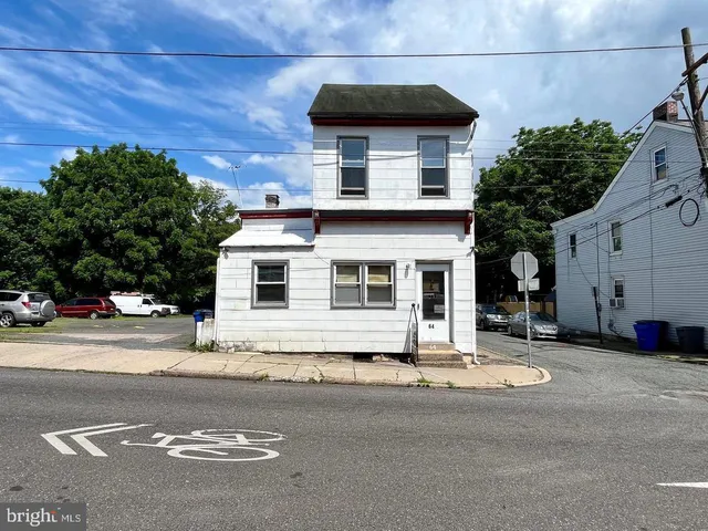 a view of a house with a yard and garage