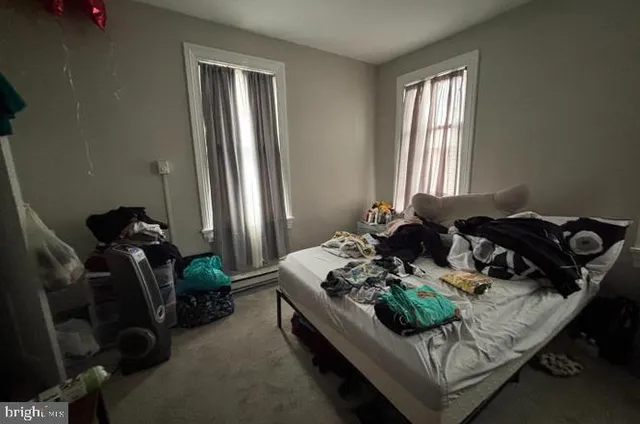 a bed room with furniture and a window