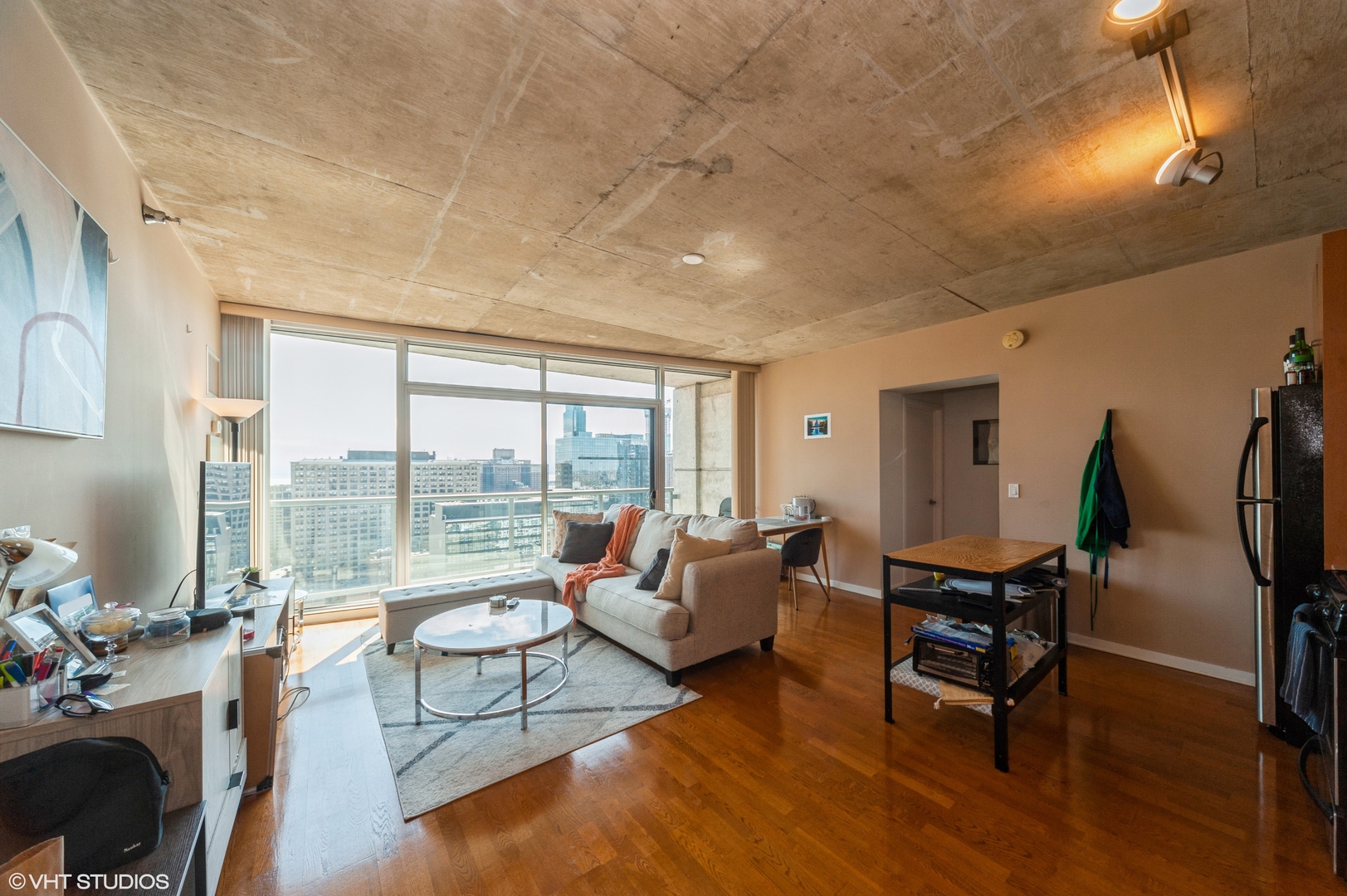 611 South Wells Street, Unit 2602 Chicago, IL 60607 - Photo 3 of 15 a living room with furniture and a large window