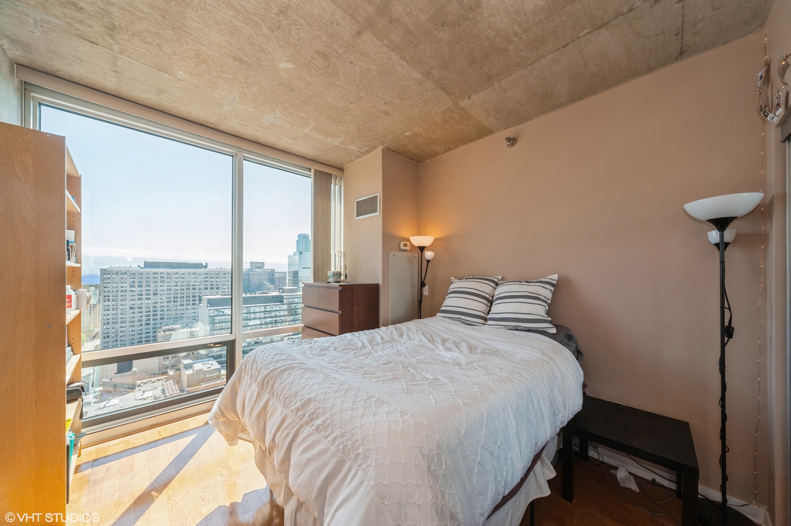 611 South Wells Street, Unit 2602 Chicago, IL 60607 - Photo 5 of 15 a bed sitting in a bedroom next to a window