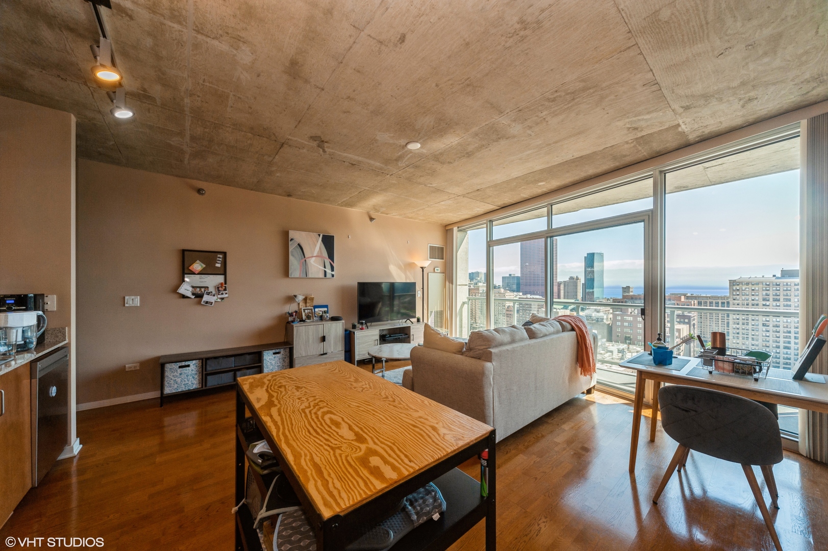 611 South Wells Street, Unit 2602 Chicago, IL 60607 - Photo 7 of 15 a living room with furniture a rug potted plant and a large window