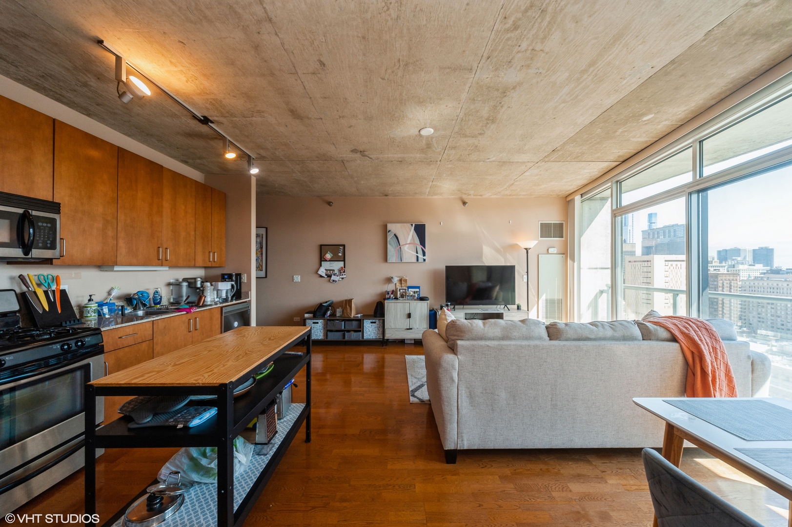 611 South Wells Street, Unit 2602 Chicago, IL 60607 - Photo 9 of 15 a living room with furniture and a flat screen tv
