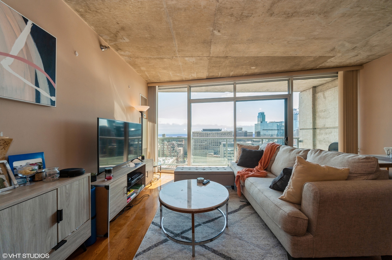 611 South Wells Street, Unit 2602 Chicago, IL 60607 - Photo 10 of 15 a living room with furniture and a flat screen tv