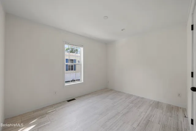 wooden floor and window in an empty room