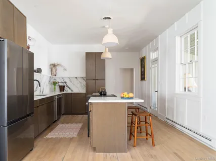 a kitchen with a table chairs refrigerator and cabinets