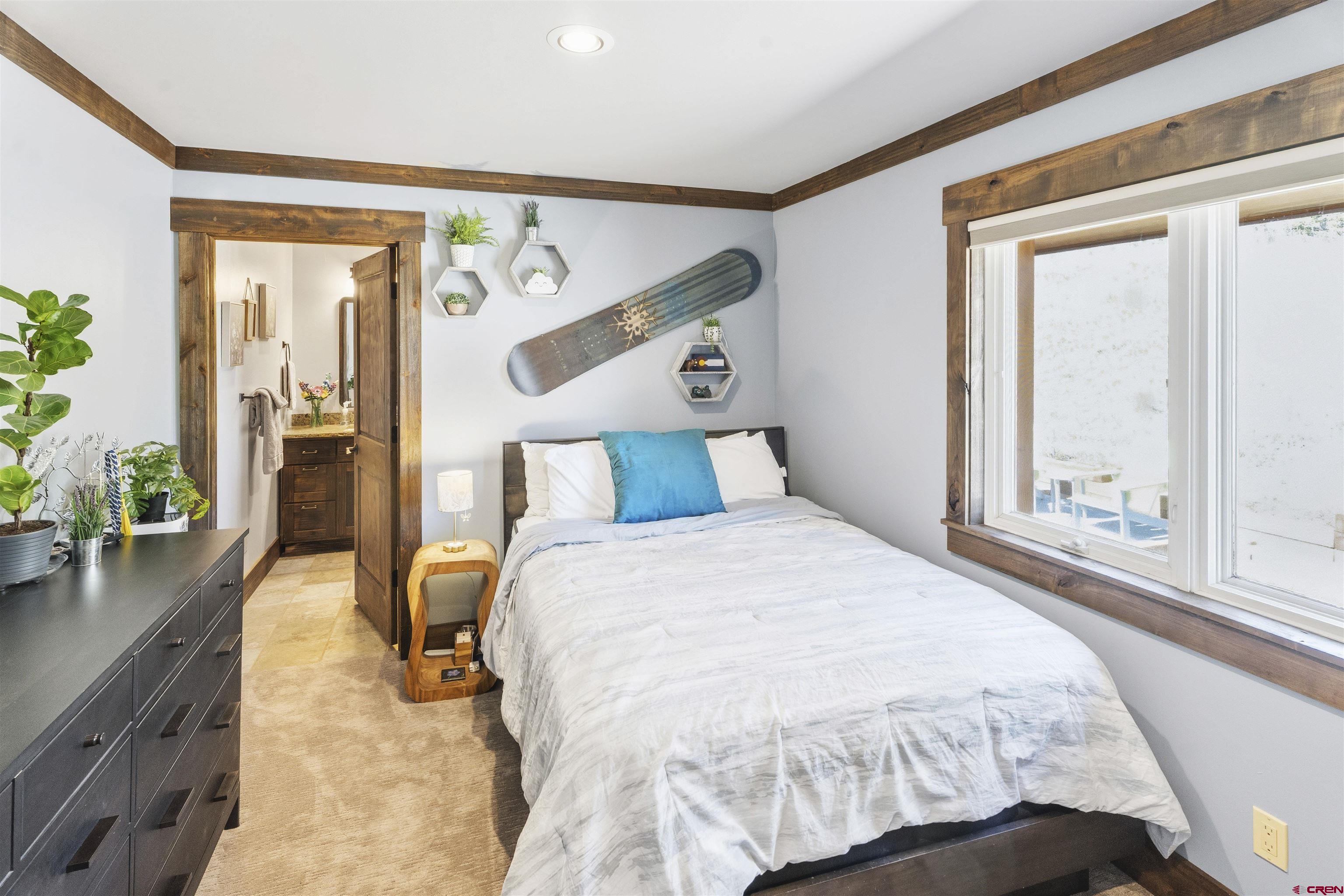 684 Falcon Way Montrose, CO 81403 - Photo 20 of 43 a bedroom with a bed and wooden floor