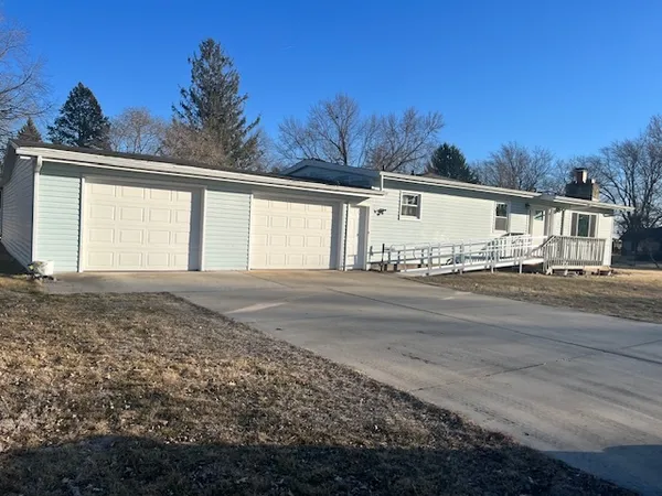 a view of a house with a snow on the road