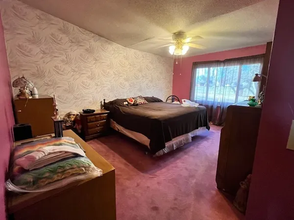 a bedroom with a bed and window