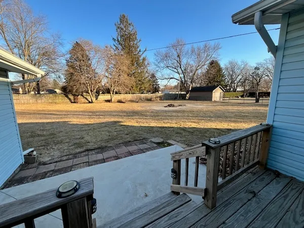 a view of a yard with wooden deck