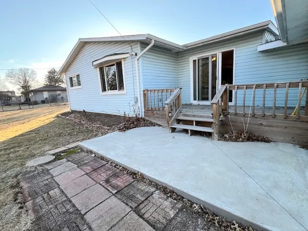 a backyard of a house with barbeque oven table and chairs