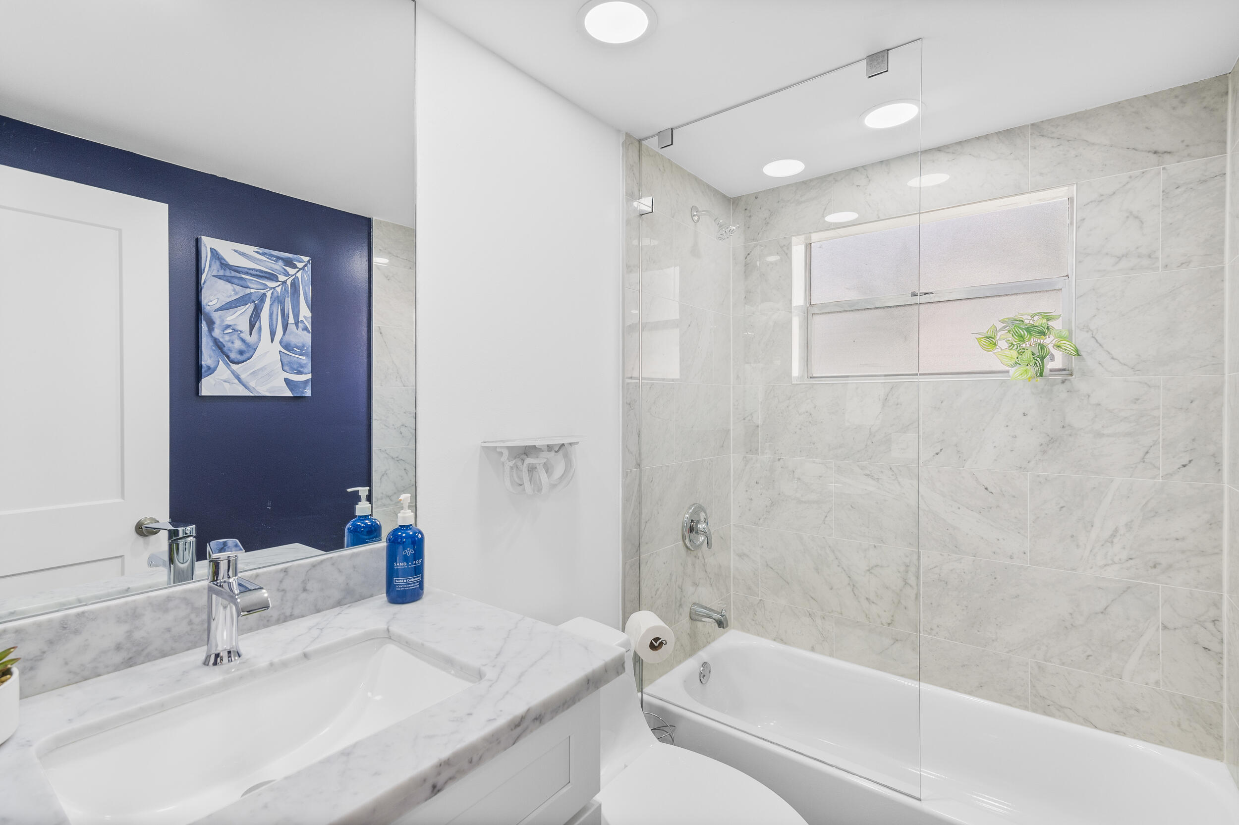 244 Monaco Way Delray Beach, FL 33446 - Photo 15 of 63 a bathroom with a bathtub and a sink